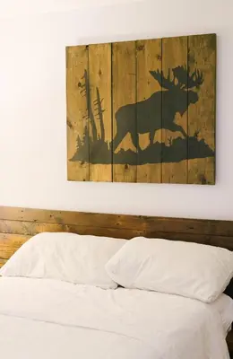 a painting of a moose on a wall above a bed at Wellington Waterfront Home in Wellington