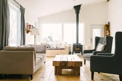a living room with two couches and a fireplace at Wellington Waterfront Home in Wellington