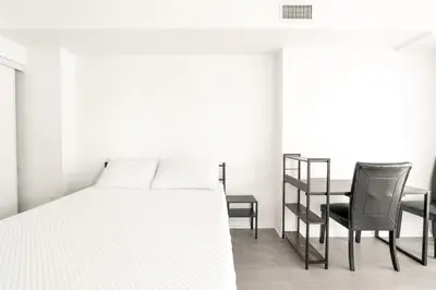 a bedroom with a bed and a desk and a chair at Toronto Downtown Elite Residence - Available for Christmas in Toronto