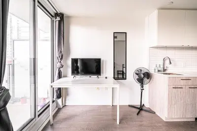 a white kitchen with a desk and a sink at Toronto Downtown Elite Residence - Available for Christmas in Toronto