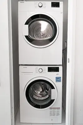 two washing machines stacked on top of each other at Toronto Downtown Elite Residence - Available for Christmas in Toronto
