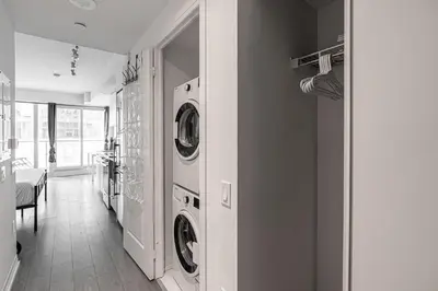 a laundry room with two washing machines in it at Toronto Downtown Elite Residence - Available for Christmas in Toronto