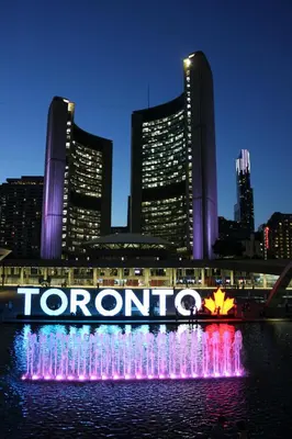 a water fountain in front of a city at night at Toronto Downtown Elite Residence - Available for Christmas in Toronto