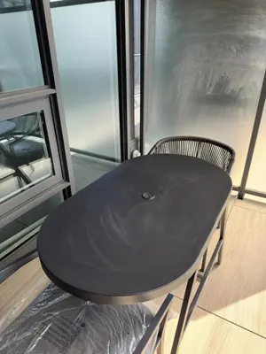 a black table and a chair in front of a window at Entire Luxe Condo in Downtown Toronto in Toronto