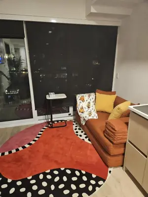 a living room with a couch and a large window at Entire Luxe Condo in Downtown Toronto in Toronto