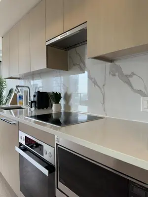 a kitchen with a stove and a counter top at Entire Luxe Condo in Downtown Toronto in Toronto