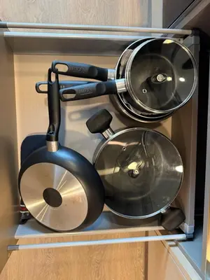 two pots and pans sitting in a drawer at Entire Luxe Condo in Downtown Toronto in Toronto