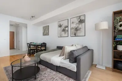 a bedroom with a bed and a table in a room at Stunning 1BD Lakeview Condo near BMO Free Parking in Toronto