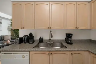 a kitchen with a sink and a counter top at Stunning 1BD Lakeview Condo near BMO Free Parking in Toronto
