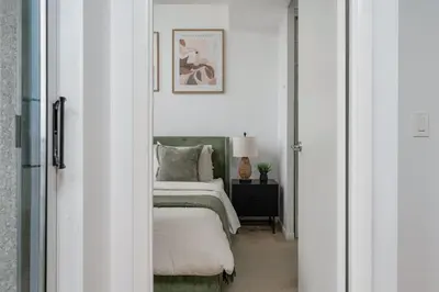 a bedroom with a bed and a framed picture on the wall at Stunning 1BD Lakeview Condo near BMO Free Parking in Toronto