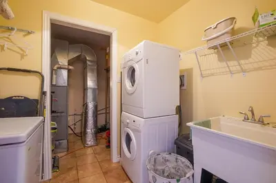 a laundry room with a washer and dryer next to a sink at Lake-Access Cottage- Hot Tub, Fireplace&Pool Table in Bewdley