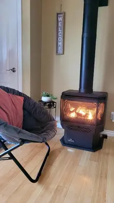 a living room with a stove and a couch at Lake-Access Cottage- Hot Tub, Fireplace&Pool Table in Bewdley