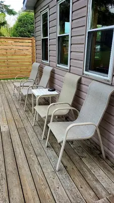 a row of chairs sitting on a deck at Lake-Access Cottage- Hot Tub, Fireplace&Pool Table in Bewdley