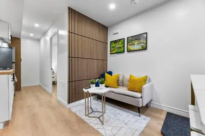 a living room with a couch and a table at High Park Grove Modern 1B1B, Kitchen, Laundry in Toronto