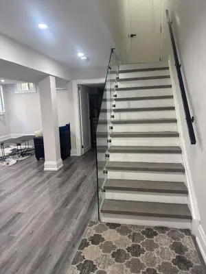 a staircase in a living room with a carpet at Hearth & Home Spacious Suite in Pickering