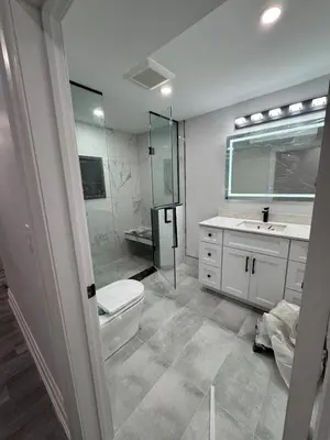 a bathroom with a shower and a toilet and a sink at Hearth & Home Spacious Suite in Pickering