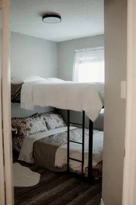 a bedroom with two bunk beds and a window at Barrie Hideaway in Barrie