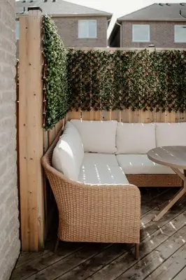 a patio with a couch and a green wall at Barrie Hideaway in Barrie