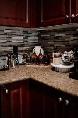 a kitchen counter with bottles of alcohol on it at Barrie Hideaway in Barrie