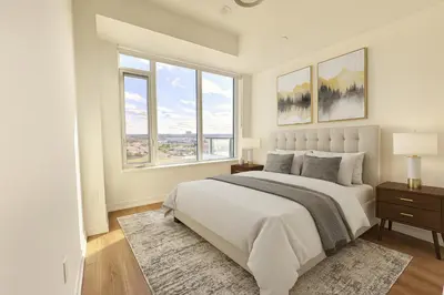 a white bedroom with a large bed and windows at Paradise - 2 Bedroom modern, cozy and luxury living in Mississauga
