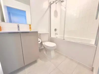 a white bathroom with a toilet and a shower at Paradise - 2 Bedroom modern, cozy and luxury living in Mississauga