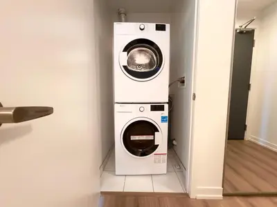 a washing machine and a dryer in a room at Paradise - 2 Bedroom modern, cozy and luxury living in Mississauga