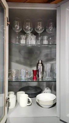 a cupboard filled with glasses and plates and dishes at Togather Time,5 minutes to HYW 401 in Oshawa