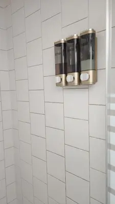 a white tiled bathroom with white subway tiles at Togather Time,5 minutes to HYW 401 in Oshawa