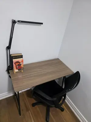 a desk with a chair next to a wall at Togather Time,5 minutes to HYW 401 in Oshawa