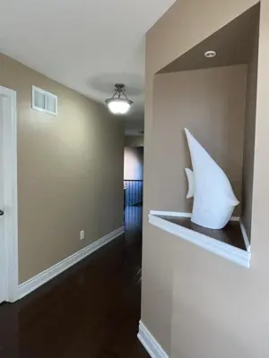 a hallway with a large white shark sculpture on the wall at 3300 SqFt - Modern and Comfort - 3 BDRM Getaway - Relax - Unwind - Explore - Near Toronto Pearson Airport & Toronto Downtown in Brampton
