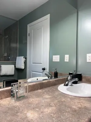 a bathroom with a sink and a mirror at 3300 SqFt - Modern and Comfort - 3 BDRM Getaway - Relax - Unwind - Explore - Near Toronto Pearson Airport & Toronto Downtown in Brampton