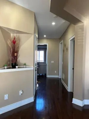 a living room with a hallway with a couch at 3300 SqFt - Modern and Comfort - 3 BDRM Getaway - Relax - Unwind - Explore - Near Toronto Pearson Airport & Toronto Downtown in Brampton