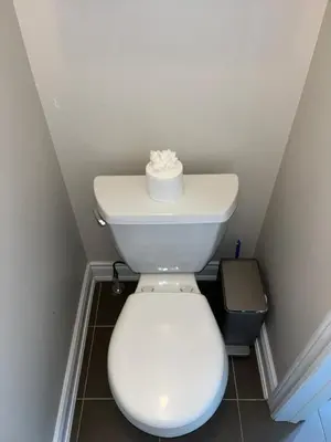 a bathroom with a toilet with a roll of toilet paper on it at 3300 SqFt - Modern and Comfort - 3 BDRM Getaway - Relax - Unwind - Explore - Near Toronto Pearson Airport & Toronto Downtown in Brampton