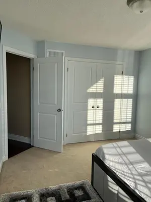 a bedroom with a bed and a white door at 3300 SqFt - Modern and Comfort - 3 BDRM Getaway - Relax - Unwind - Explore - Near Toronto Pearson Airport & Toronto Downtown in Brampton