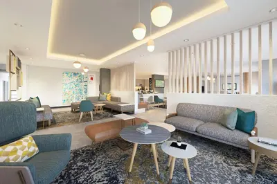 a living room with couches and tables at TownePlace Suites by Marriott Woodstock in Woodstock