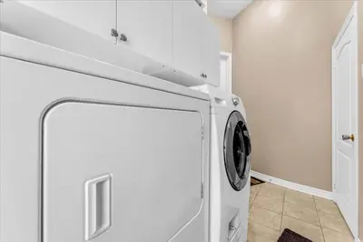 a white laundry room with a washer and dryer at Luxury Mansion by Toronto and YYZ with Large Backyard Weddings in Brampton