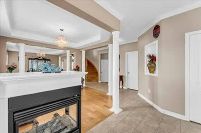 a living room with a fireplace and a hallway at Luxury Mansion by Toronto and YYZ with Large Backyard Weddings in Brampton