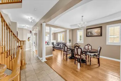 a dining room and living room with a table and chairs at Luxury Mansion by Toronto and YYZ with Large Backyard Weddings in Brampton
