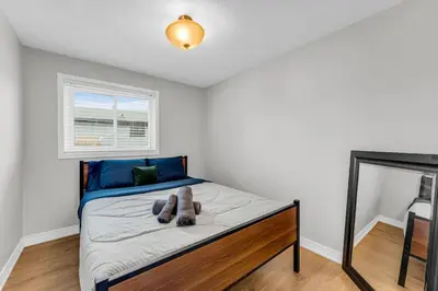 a bedroom with a bed with a teddy bear on it at Bright 6BR Near Niagara Falls with BBQ Yard in Thorold