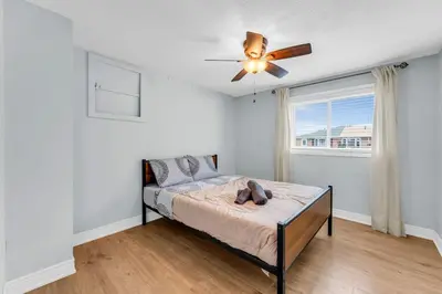 a bedroom with a bed and a ceiling fan at Bright 6BR Near Niagara Falls with BBQ Yard in Thorold
