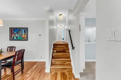 a staircase in a home with a table and a dining room at Bright 6BR Near Niagara Falls with BBQ Yard in Thorold