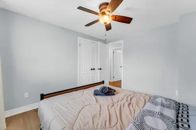 a bedroom with a bed and a ceiling fan at Bright 6BR Near Niagara Falls with BBQ Yard in Thorold