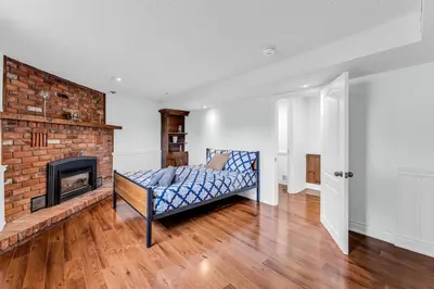 a living room with a fireplace and a couch at Bright 6BR Near Niagara Falls with BBQ Yard in Thorold