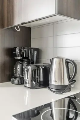 a kitchen with pots and pans on a counter at Modern 1 Bedroom Condo Front Street Downtown Toronto in Toronto
