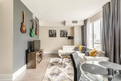 a living room with a white couch and a table at Modern 1 Bedroom Condo Front Street Downtown Toronto in Toronto