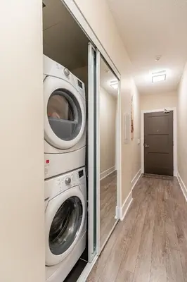 a laundry room with a washer and dryer at Modern 1 Bedroom Condo Front Street Downtown Toronto in Toronto