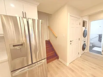 a kitchen with a stainless steel refrigerator at Modern 1-BR Suite EV Charger, Backyard BBQ & Near Square One in Mississauga