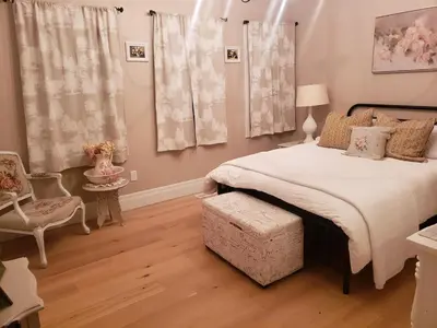 a bedroom with a large bed and a chair at Luxury Countryside Villa in Waterford