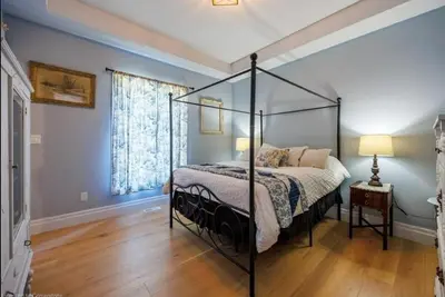 a bedroom with a canopy bed and a wooden floor at Luxury Countryside Villa in Waterford