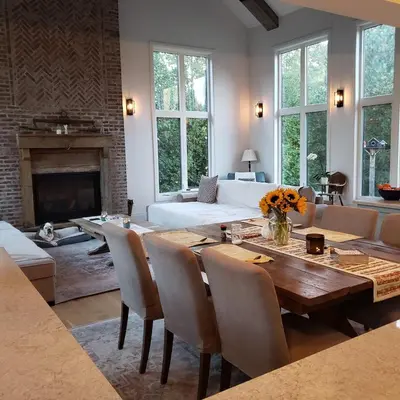 a living room with a wooden table and a fireplace at Luxury Countryside Villa in Waterford